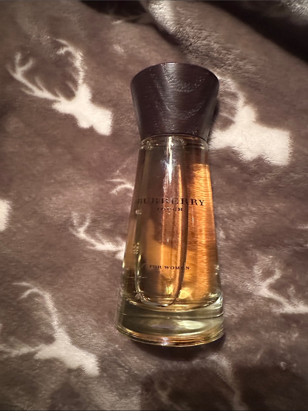 Burberry women's perfume bottle in amber and dark brown